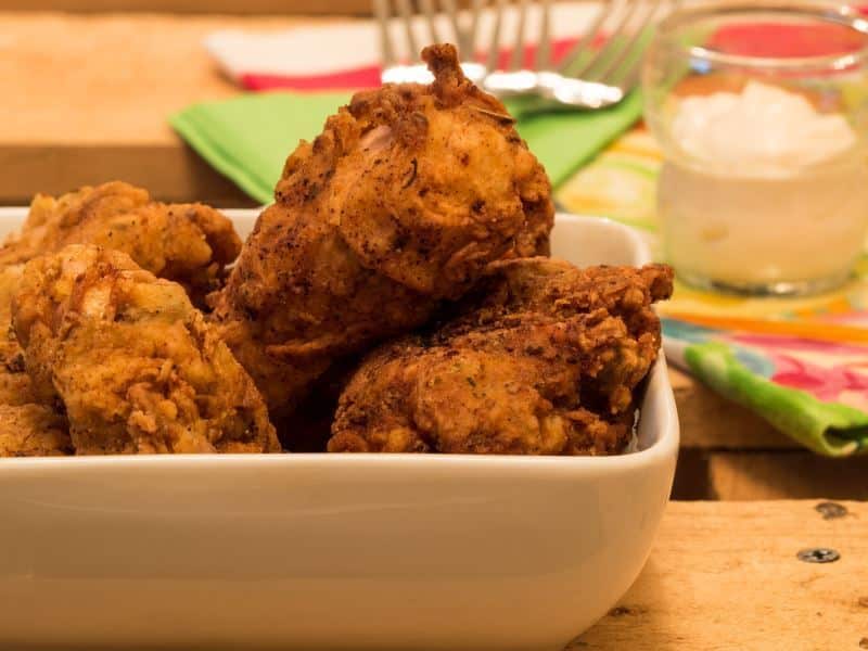 Fried chicken pieces in a porcelain dish.