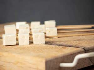 How to Fry Tofu - Step 2 image of cubed tofu on cutting board. inthekitch.net