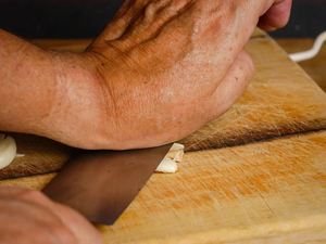 How to Chop Garlic - Step 3 image, smashing the garlic. inthekitch.net