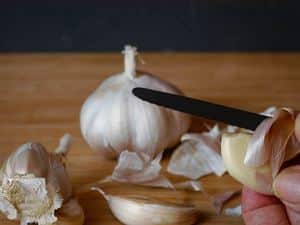 How to Chop Garlic - Step 2 image, peeling the garlic. inthekitch.net