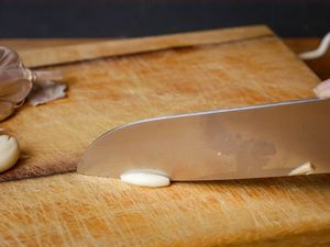 How to Chop Garlic - Step 4 image, slicing the garlic into strips. inthekitch.net