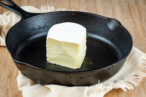 Brie wedge in a cast iron pan.