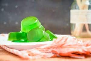 Green gummies on a plate.