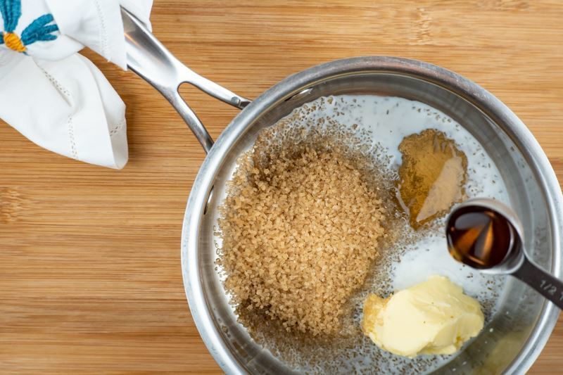 Adding syrup to pot with sugar in it.
