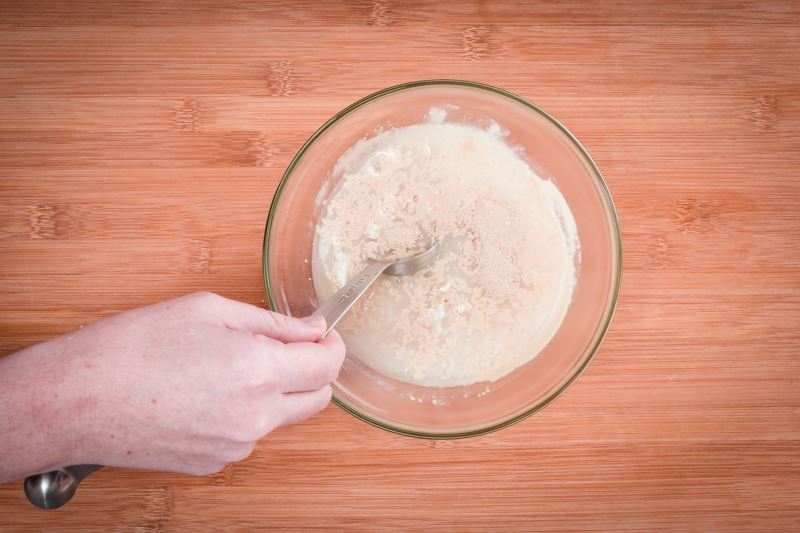 Mixing yeast and water in a bowl.