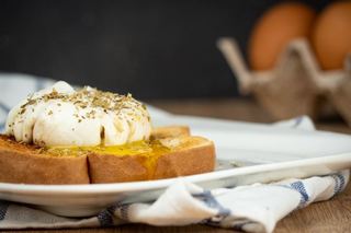 How to Sous Vide Eggs Step 11 Poached - finished sous vide egg on top of toast on plate.