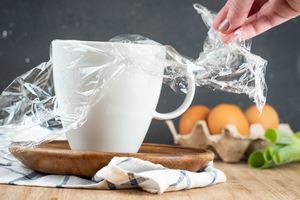 Step 1 image of placing plastic wrap in mug.