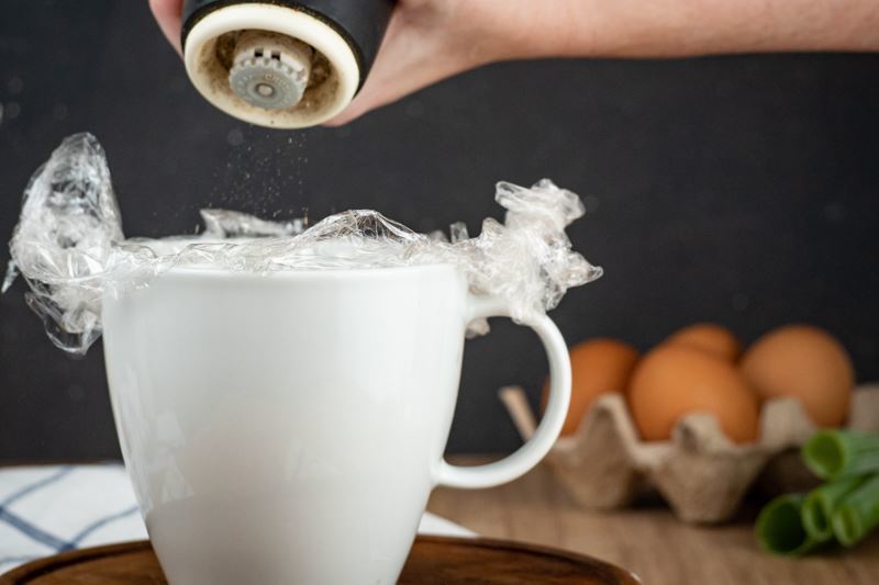 How to Sous Vide Eggs Step 5-2 Poached - adding seasoning to mug.