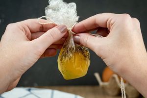 How to Sous Vide Eggs Step 7 Poached - tying string around pouch of egg.