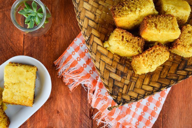 Electric Skillet Corn Bread in a wooden woven basket, a succulent on the table.