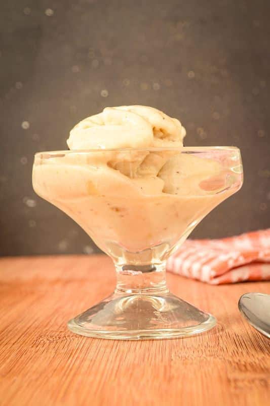 Banana ice cream in a glass serving dish.