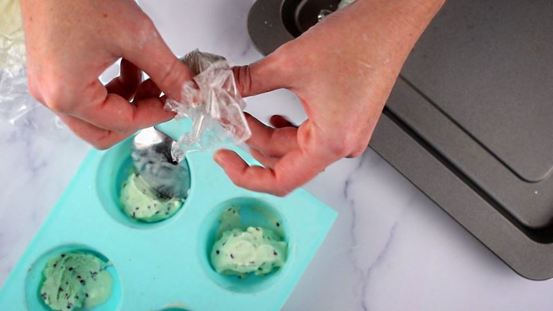 How to Make Mochi Ice Cream Step 7-5 Woman's hand wrapping the plastic wrap around the dough ball.
