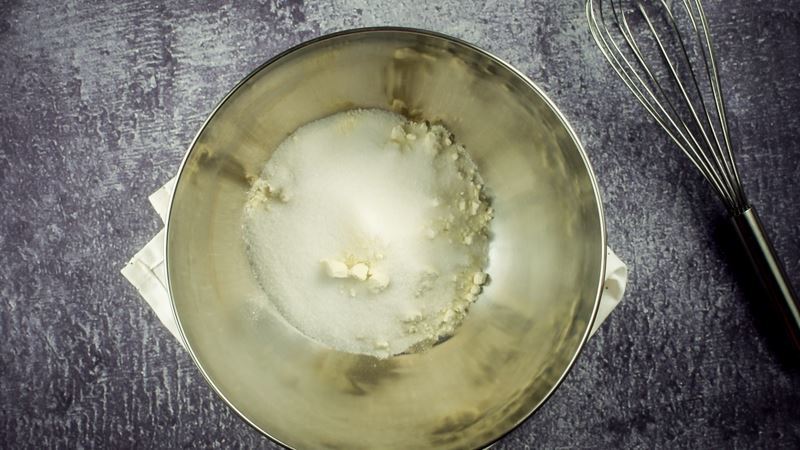 Bowl of flour and sugar, whisk on the side.