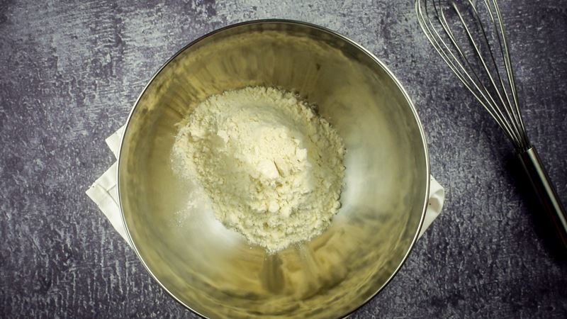 Bowl of flour, whisk on the side.