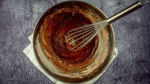 Donut cake mix mixed together in a bowl with whisk.