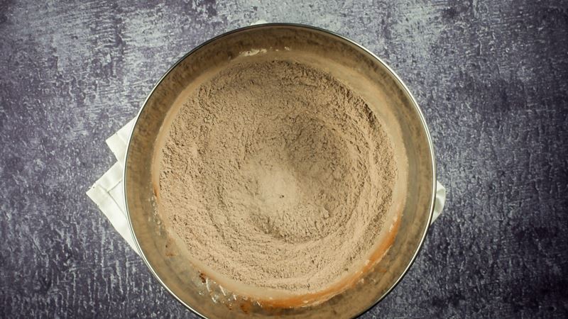 Bowl of chocolate donut ingredients mixed together.