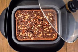 Uncut brownies in a pan in the electric skillet.