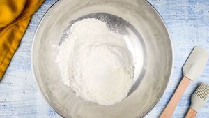Cake mix in a bowl, spatula and pastry brush on the side.
