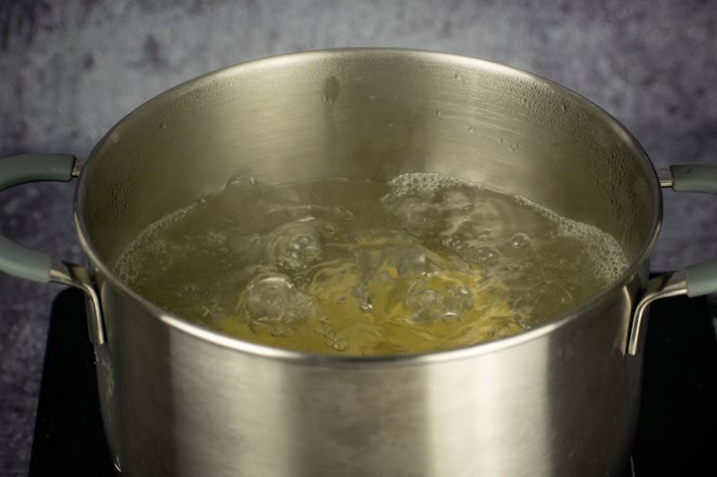 Potatoes boiling in a pot of water.
