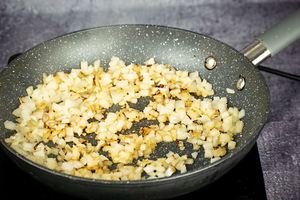 Chopped onions cooked in a pan.