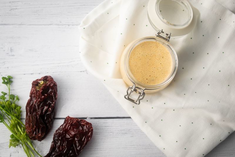 How to make chipotle sauce Step 3-4 Chipotle sauce in a jar, chipotle peppers on the side.