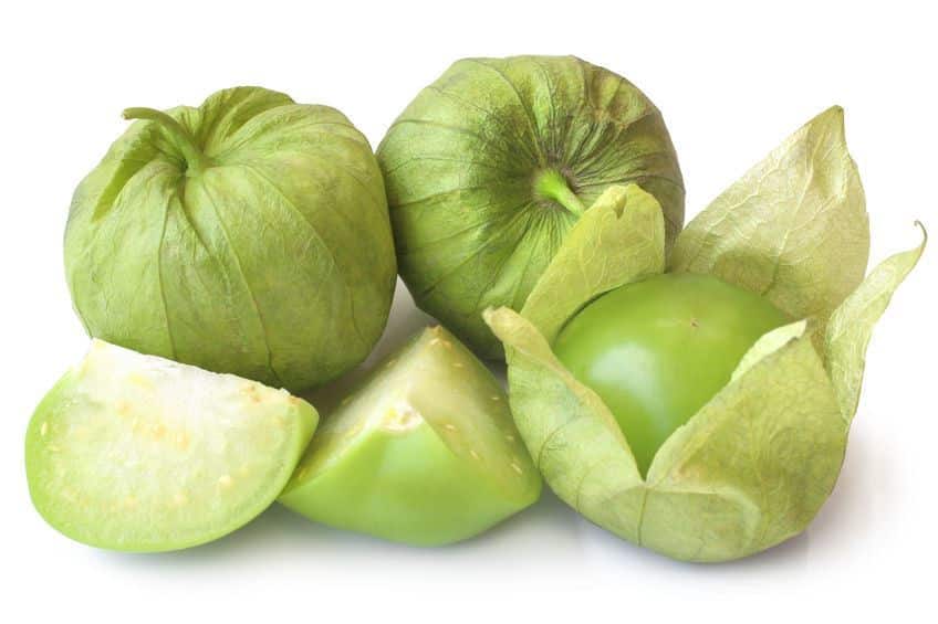 Fresh green tomatillos (Physalis philadelphica) with a husk on white background