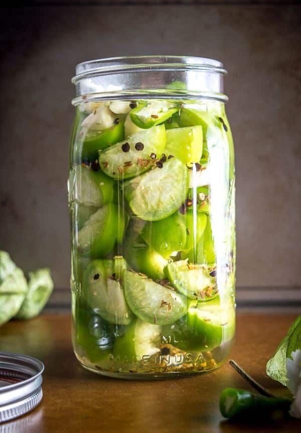 A jar of pickled tomatillos.