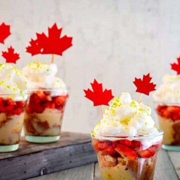 Canada Day Three Milks Cake with Strawberries in shot glasses.