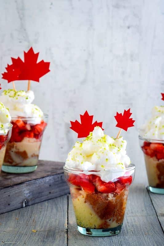 Canada Day Three Milks Cake with Strawberries in shot glasses.