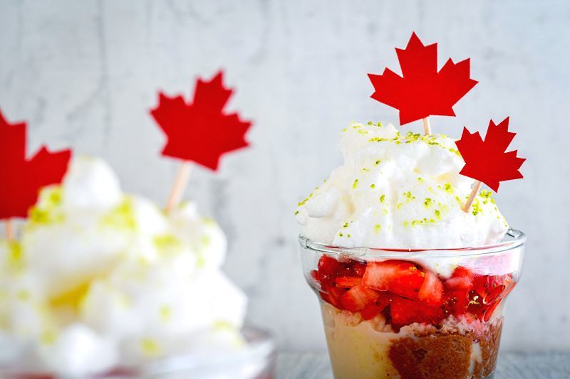 Close up of Canada Day Three Milks Cake with Strawberries in shot glasses.