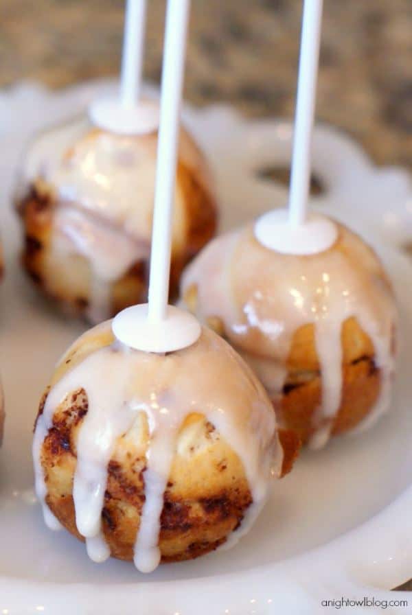 Cinnamon Roll Cake Pops upside down on a tray.