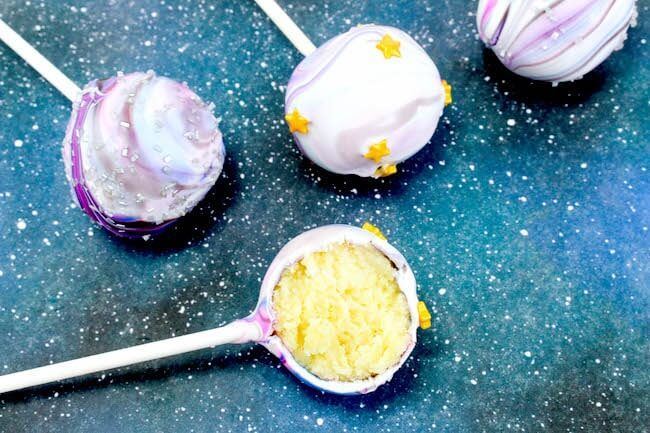 Galaxy cake pops on a starry background.