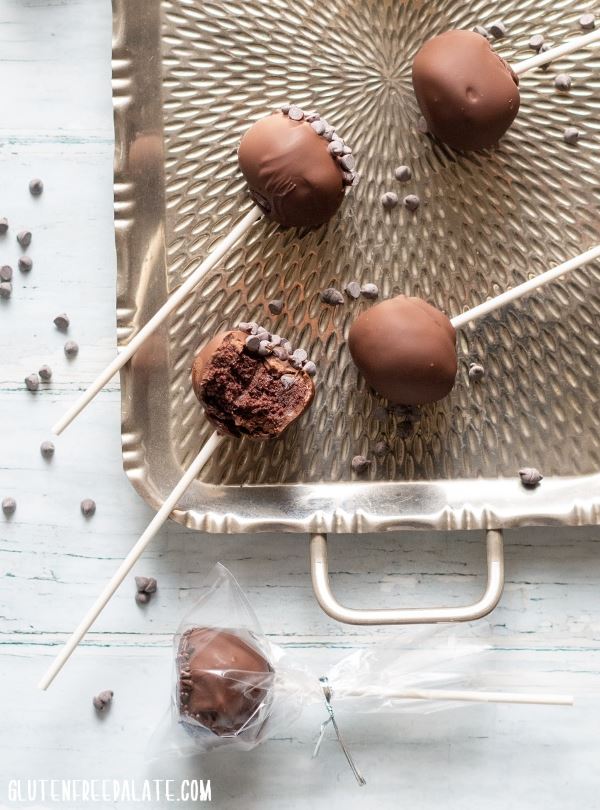 Chocolate gluten free cake pops laid out on a serving tray.