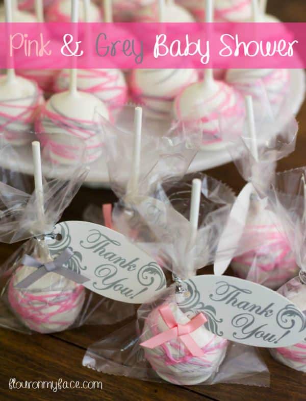 White girl baby shower cake pops with pink and silver icing drizzles and clear packaging plus thank you notes.