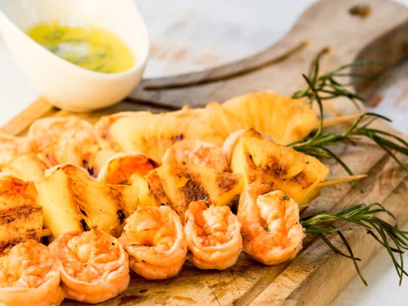 Shrimp on Rosemary Skewers with Rum-Soaked Pineapple Shrimp on Rosemary Skewers with Rum-Soaked Pineapple wedges.