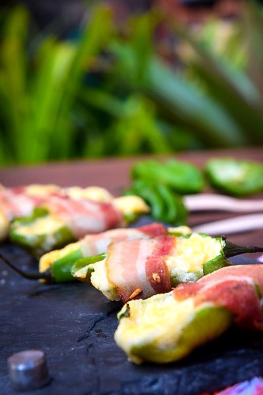 How to Grill Jalapeño Poppers_21 Grilled jalapeno poppers on a black rectangular serving tray.