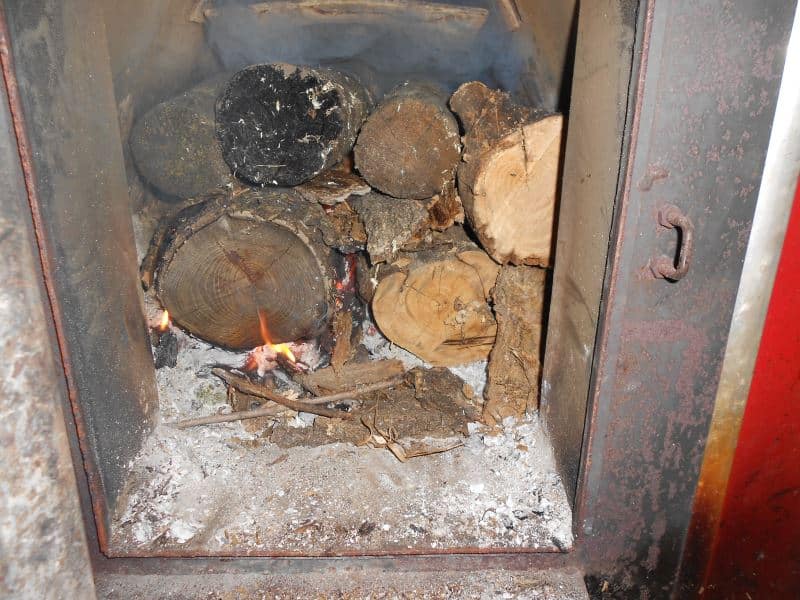 A wood fire started in a furnace.