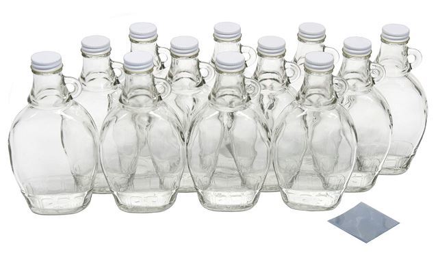 Maple syrup glass jars with lids and shrink bands.