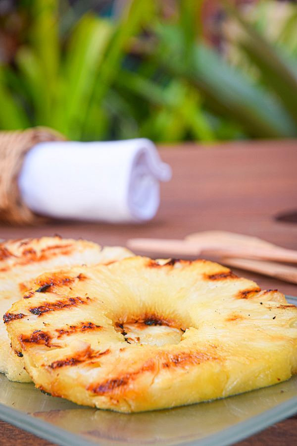 How to Grill Pineapple Slices_15 Grilled pineapple slices on a glass serving plate.