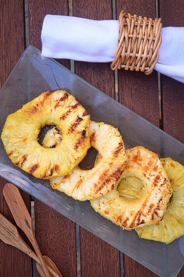 How to Grill Pineapple Slices_17 Grilled pineapple slices on a glass serving plate.