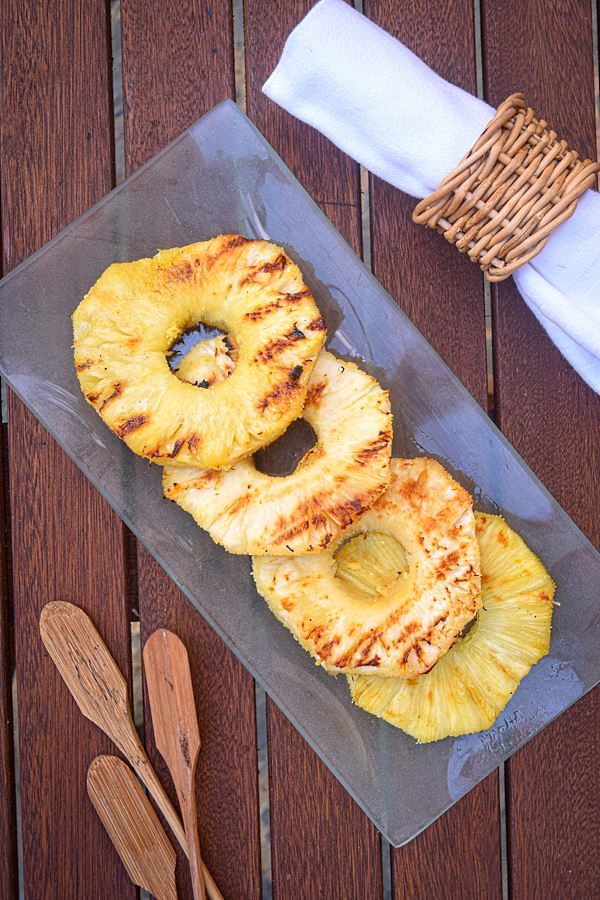How to Grill Pineapple Slices_18 Grilled pineapple slices on a glass serving plate.