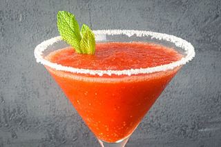 Frozen strawberry margarita with fresh mint leaves.