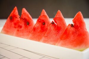 Triangle watermelon slices on a white serving dish.