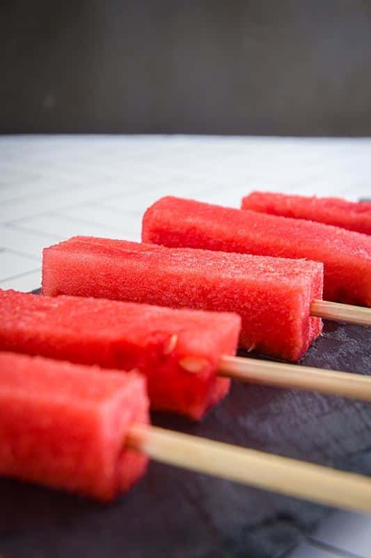 Watermelon sticks on wooden sticks.