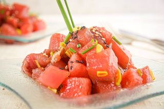 Tuna and Watermelon Tartare on a clear glass square plate.