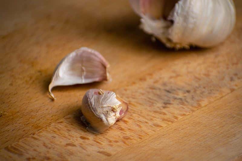 Garlic on a wooden cutting board.