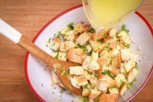 Stuffing in a bowl, wooden background, vegetable stock.
