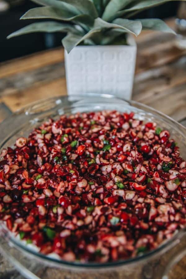 Cranberry jalapeno dip in a clear glass bowl.