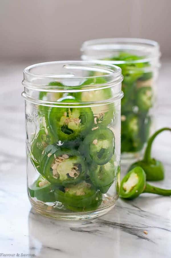 Canned jalapeno slices in 2 small jars.