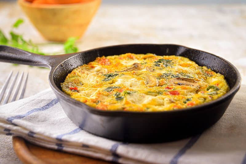 Vegetable and Goat Cheese Frittata_1 Electric Skillet Vegetable and Goat Cheese Frittata on a pie server and in a cast iron pan.